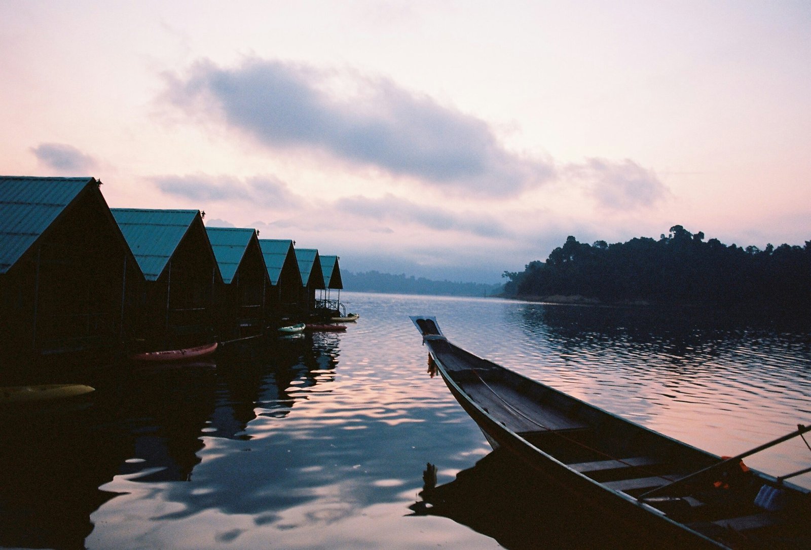 A row of boats sitting on top of a lake